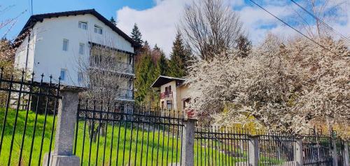 a wrought iron fence in front of a house at Iepurasul Sinaia in Sinaia