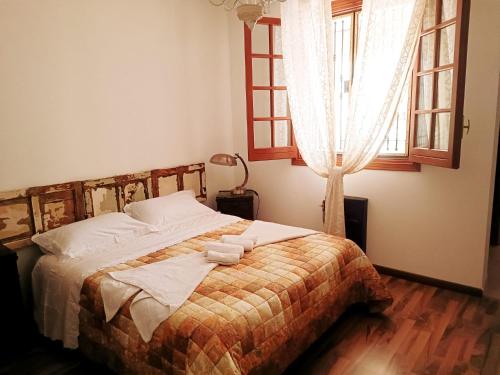 a bedroom with a bed with two towels on it at Princess House Palermo - Intero Appartamento - Mondello in Mondello