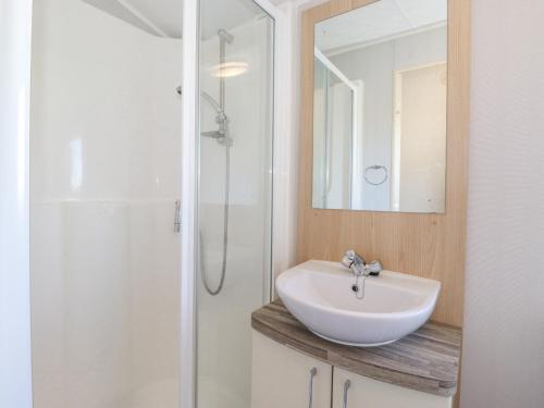a bathroom with a white sink and a shower at Swinside in Cockermouth