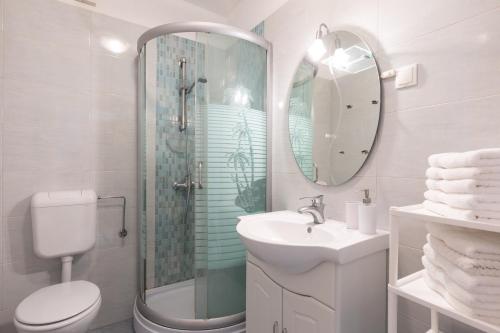 a bathroom with a toilet sink and a shower at Apartments Mirjana * central location and close to beach in Punat
