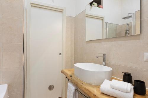 a bathroom with a white sink and a shower at Old Town Pavia in Pavia