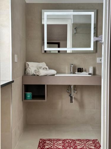 a bathroom with a sink and a mirror at Hotel Villa Cedrino in Dorgali