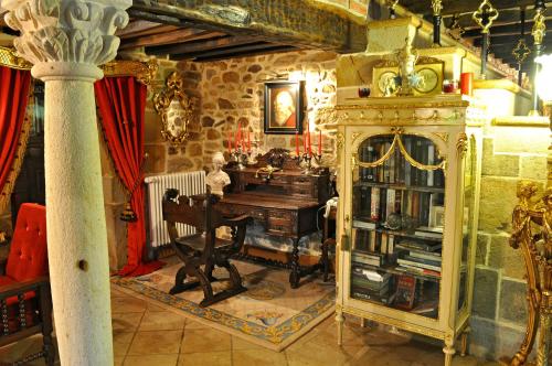 a room with a wooden desk in a stone room at Palacio de Trasvilla in Escobedo