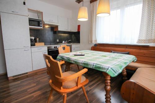 a kitchen with a table and chairs in a room at Haus Kinspergher in Innsbruck