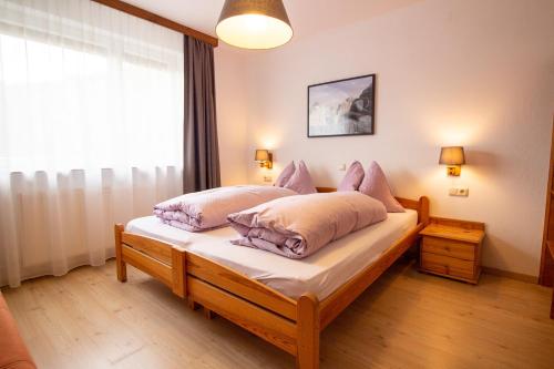 a bedroom with a bed with two pillows on it at Haus Kinspergher in Innsbruck