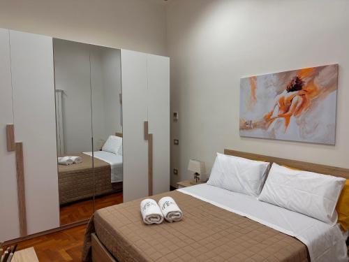 a bedroom with a bed with two slippers on it at Zara Palace - Tasso in Scafati