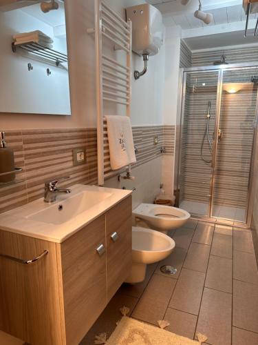 a bathroom with a sink and a toilet and a shower at Zara Palace - Tasso in Scafati