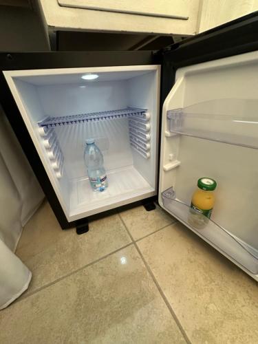 拿坡里的住宿－B&B Pantarei Napoli，配有一瓶水和两杯饮料的开放式冰箱