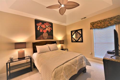 a bedroom with a bed and a ceiling fan at Great Golf View Condo WT 3th Floor in Myrtle Beach