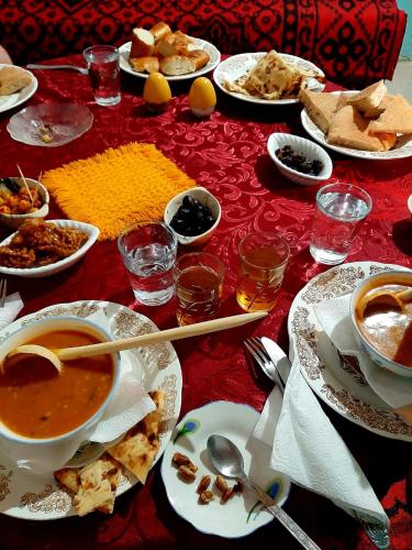 a table with plates of food and bowls of soup at maison isabel in Boumalne