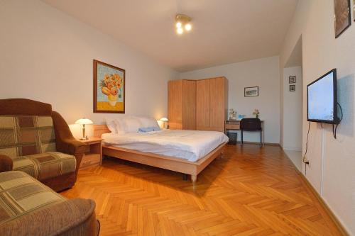 a bedroom with a bed and a tv and a couch at Atlas Accommodation Studio Romana de Lux in Bucharest