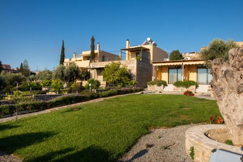 a large house with a lawn in front of it at Sivas Apartments-Studios,Sigelakis with very nice view in Sívas
