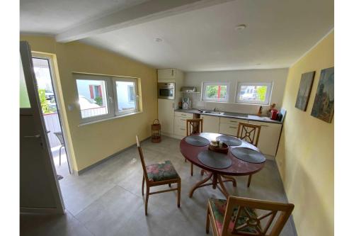 a kitchen and dining room with a table and chairs at Ferienhaus Dorfstrasse 12a in Loddin