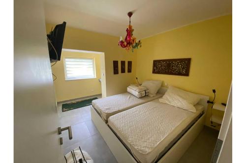 a bedroom with a bed and a chandelier at Ferienhaus Dorfstrasse 12a in Loddin