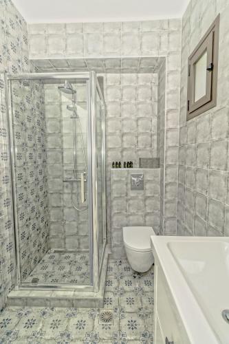 a bathroom with a shower and a toilet and a sink at Friday Mood by Diomedes Group in Pefkochori