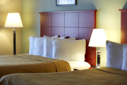 a hotel room with two beds and two lamps at Quality Inn Southampton in Southampton