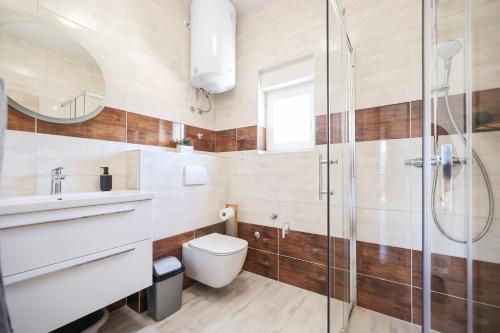a bathroom with a toilet and a glass shower at Apartment Bojana in Petrcane
