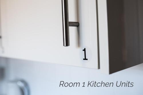 a white kitchen cabinet with the number on it at Town House Chantry - With Self Check In and Free Parking - Rooms at ipswichdigs in Ipswich