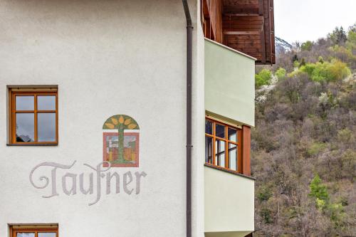 a building with the word summer painted on the side of it at Taufner Apartement B 107 in Parcines