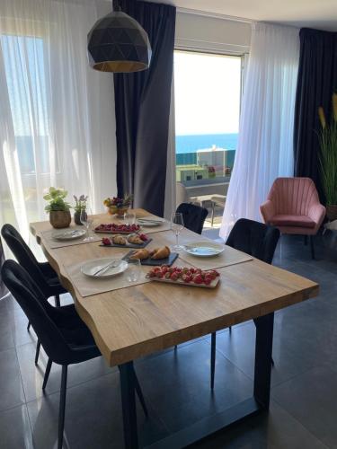a wooden table with food on it in a living room at Villa Donatella in Podstrana