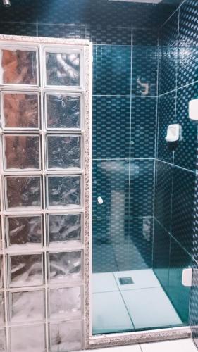 a glass shower with a glass door in a bathroom at Hotel La Costa - Adults Only in Rio de Janeiro