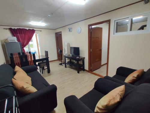 a living room with two couches and a table at Zenmist Properties- 2 Bedroom Deluxe in Baguio
