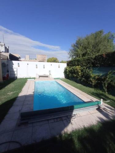 a swimming pool in the middle of a yard at La Josefina. in Maipú