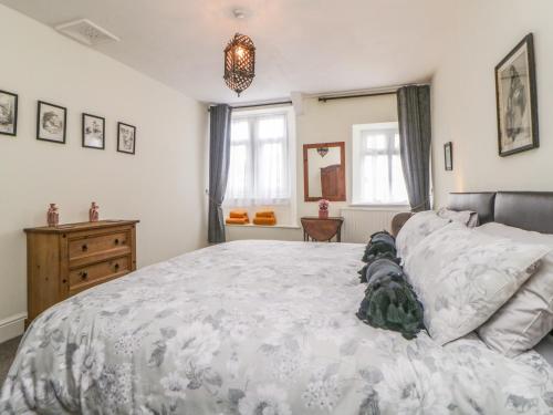 a bedroom with a large bed with a stuffed animal on it at Harmony House in Yelverton