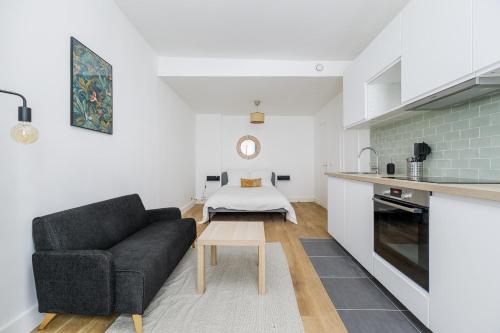 a living room with a couch and a table at Bridgestreet Le Marais - les halles in Paris