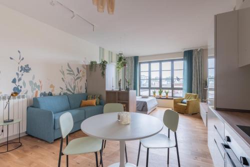 a living room with a blue couch and a table at Smart loft in Milan - in Milan