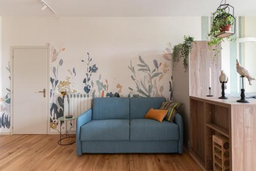 a blue couch in a living room with a wall at Smart loft in Milan - in Milan