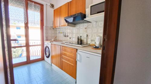 a kitchen with a washer and dryer and a window at Casa Marina - Spacious Home in Rapallo in Rapallo