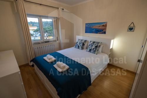 a bedroom with a bed with two towels on it at Home Sweet Home by ACasaDasCasas in Ericeira