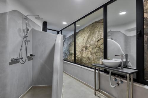 a bathroom with a shower with a sink and a mirror at Villa Cataleya 1 PRIVATE POOL in Fanari