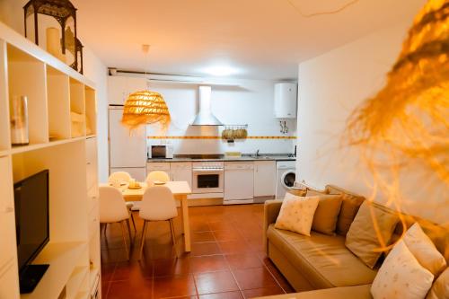 a living room with a couch and a table at Apartamentos Costa Norte in San Vicente de la Barquera