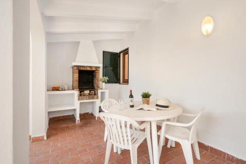 a dining room with a white table and chairs at Villa Misuco in Son Parc
