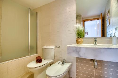 a bathroom with a toilet and a sink at Lola in L'Escala