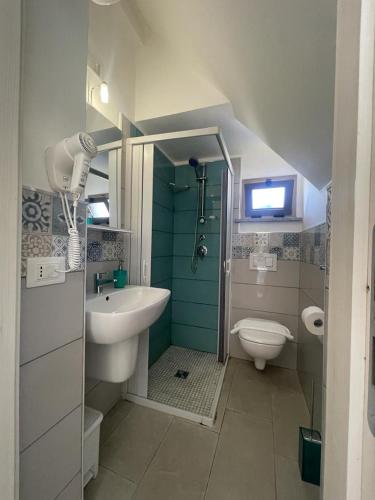 a bathroom with a sink and a shower and a toilet at La Tonnara B&B in Palmi