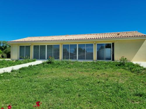a house with a large yard in front of it at Le Cocon de Lily in Saint-Savin-de-Blay