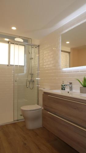 a bathroom with a shower and a toilet and a sink at Club Náutico Altea Playa in Altea