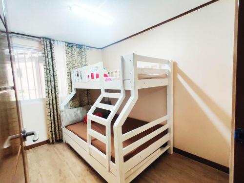 a bunk bed with a ladder in a room at Zenmist Properties- 2 Bedroom Deluxe in Baguio