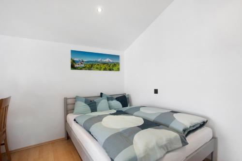 a bedroom with a large bed with blue pillows at Lackner in Teisendorf