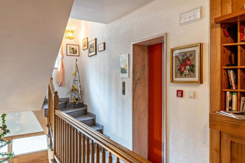 a staircase in a home with a red door at Taufner Apartement B 104 in Parcines