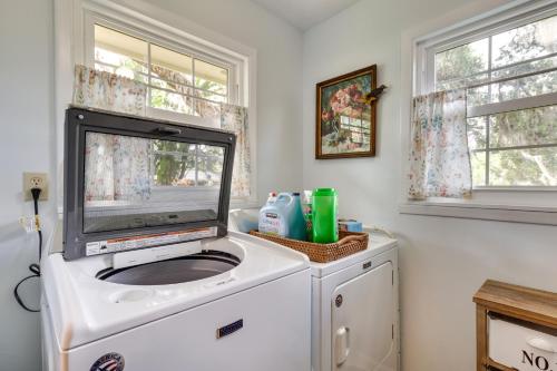 a tv sitting on top of a washing machine at Mount Dora Vacation Rental Steps to Lake Gertrude in Mount Dora