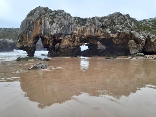 an arch in a rock formation on the beach at Hotel Hontoria in Hontoria