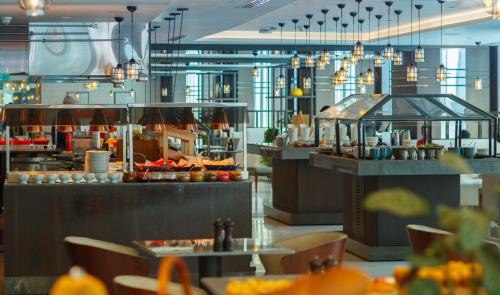 a restaurant with a buffet line of food at Marriott Marquis City Center Doha Hotel in Doha