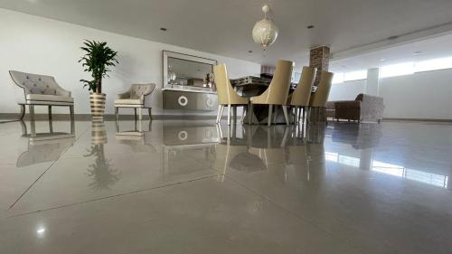 a living room with a dining table and chairs at HELENE HOUSE in Sincelejo