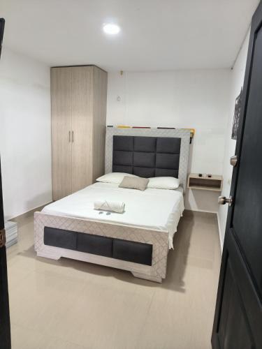 a bedroom with a large bed in a room at HELENE HOUSE in Sincelejo