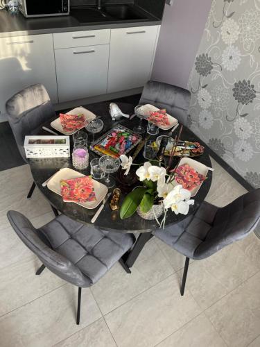 a dining room table with plates of food on it at Apartment SAMANTA- self-checkin - near Jurmala, airport in Piņķi