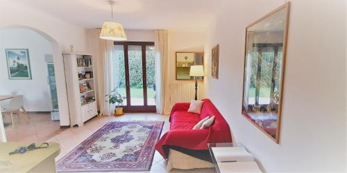 a living room with a red couch and a table at Giada Palace - Pool & Resort in Lucca